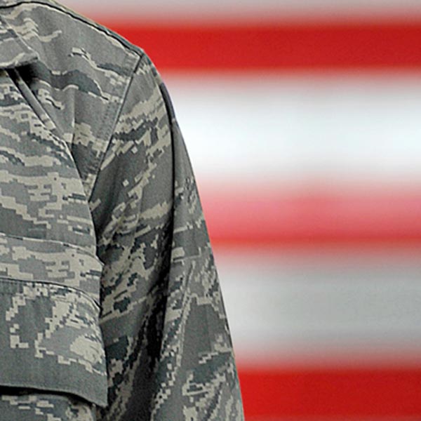 Tile Image for CEMM.org. A soldier's blouse is shown with an American flag in the background.